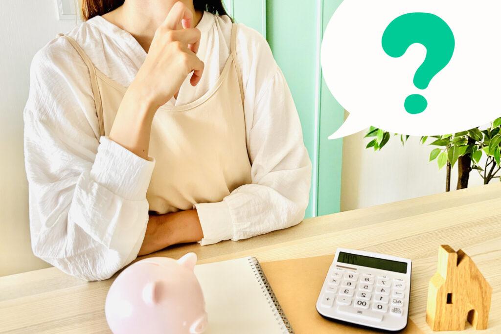 お金に悩む女性とはてなマークの画像